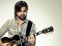 Juanes playing guitar.