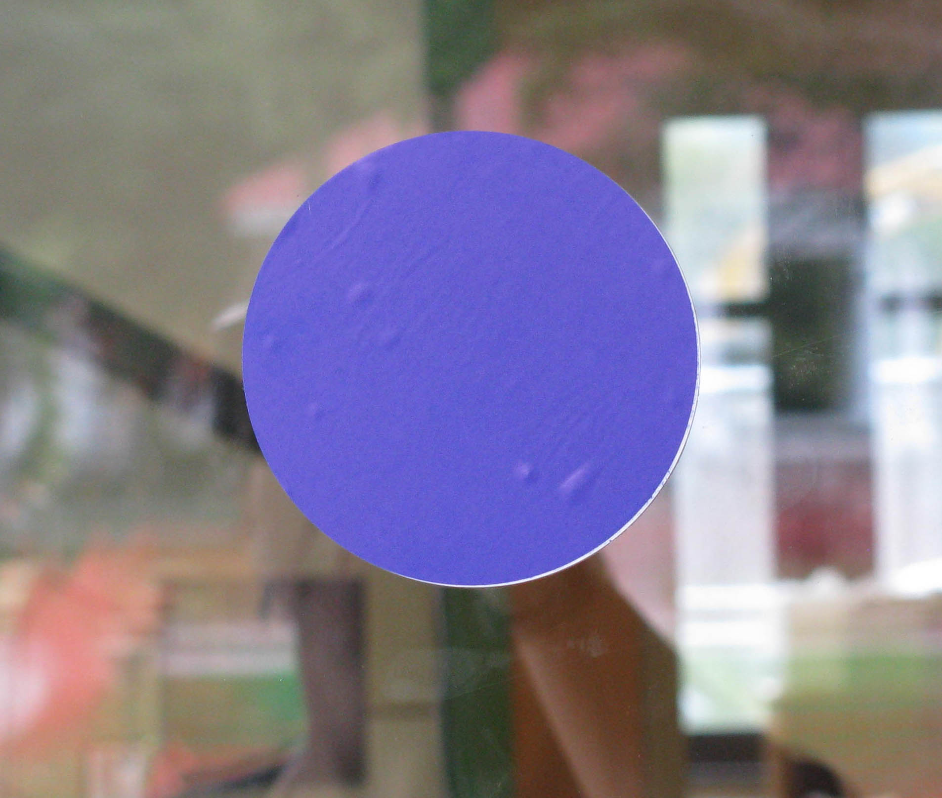 purple dot on glass circle